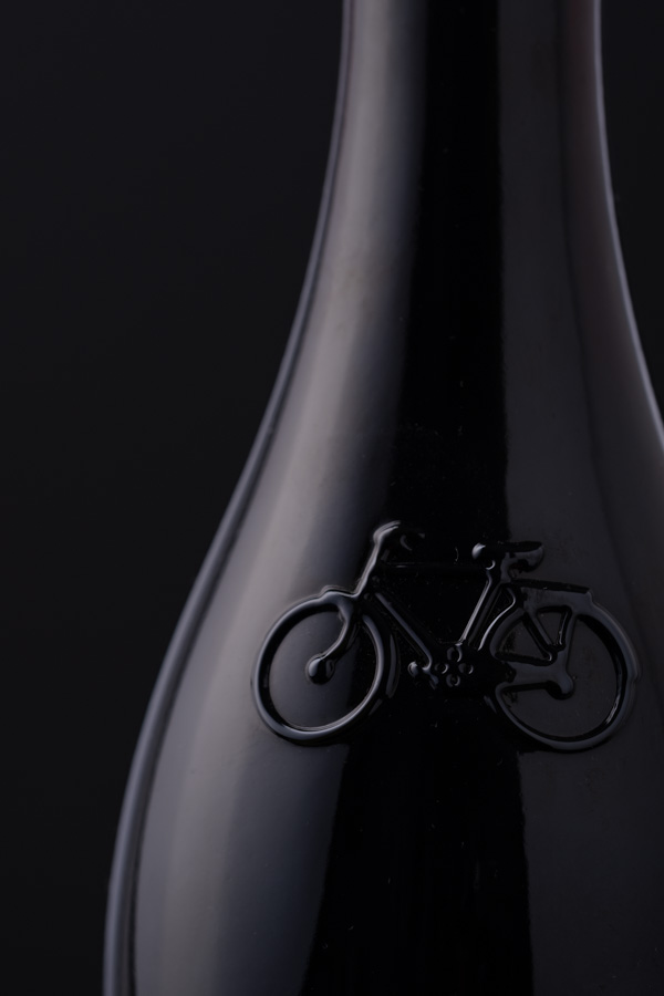 photo of a black bottle on a black background
